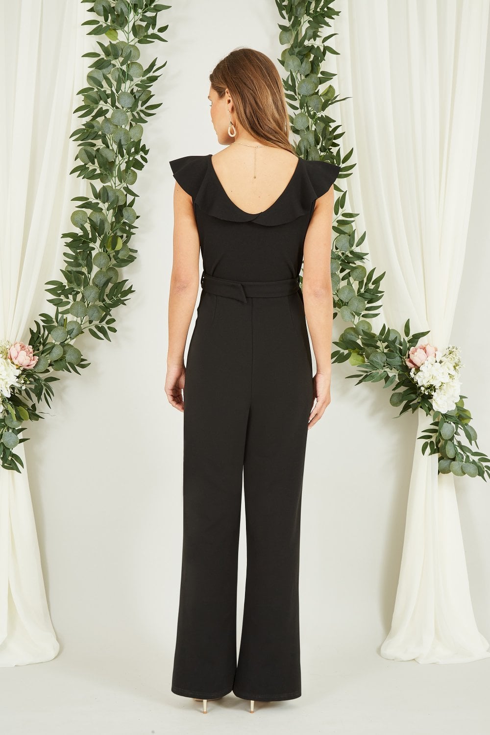 Mela Black Jumpsuit With Gold Buckle and Frill Detail Mela