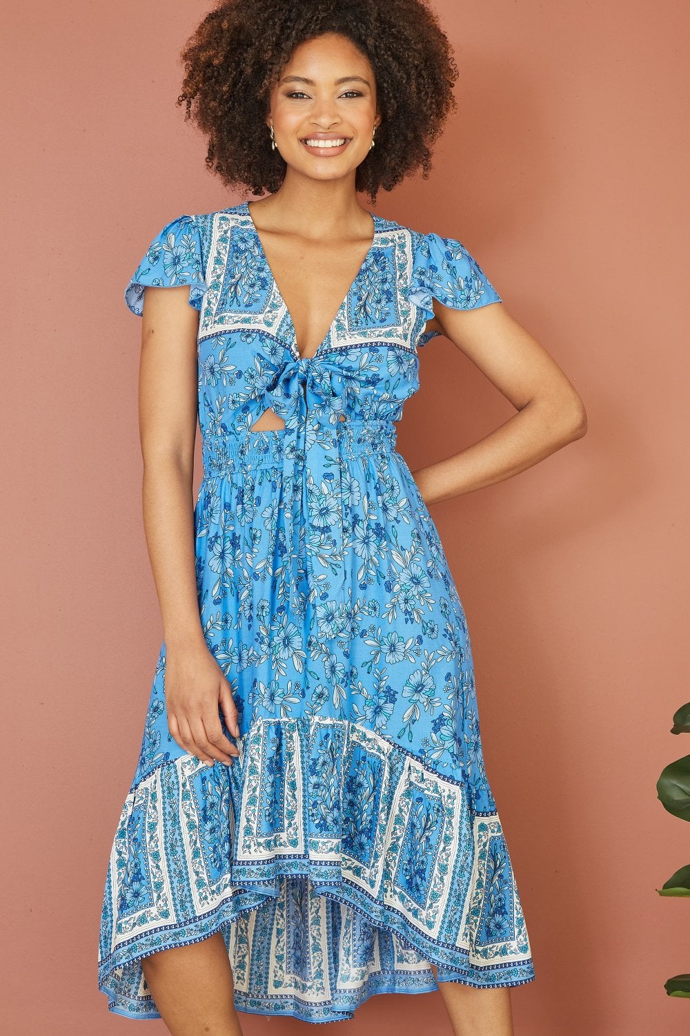 Mela Blue Ditsy Print Sun Dress With Cross Over Back Tie Front And Dip Hem Mela