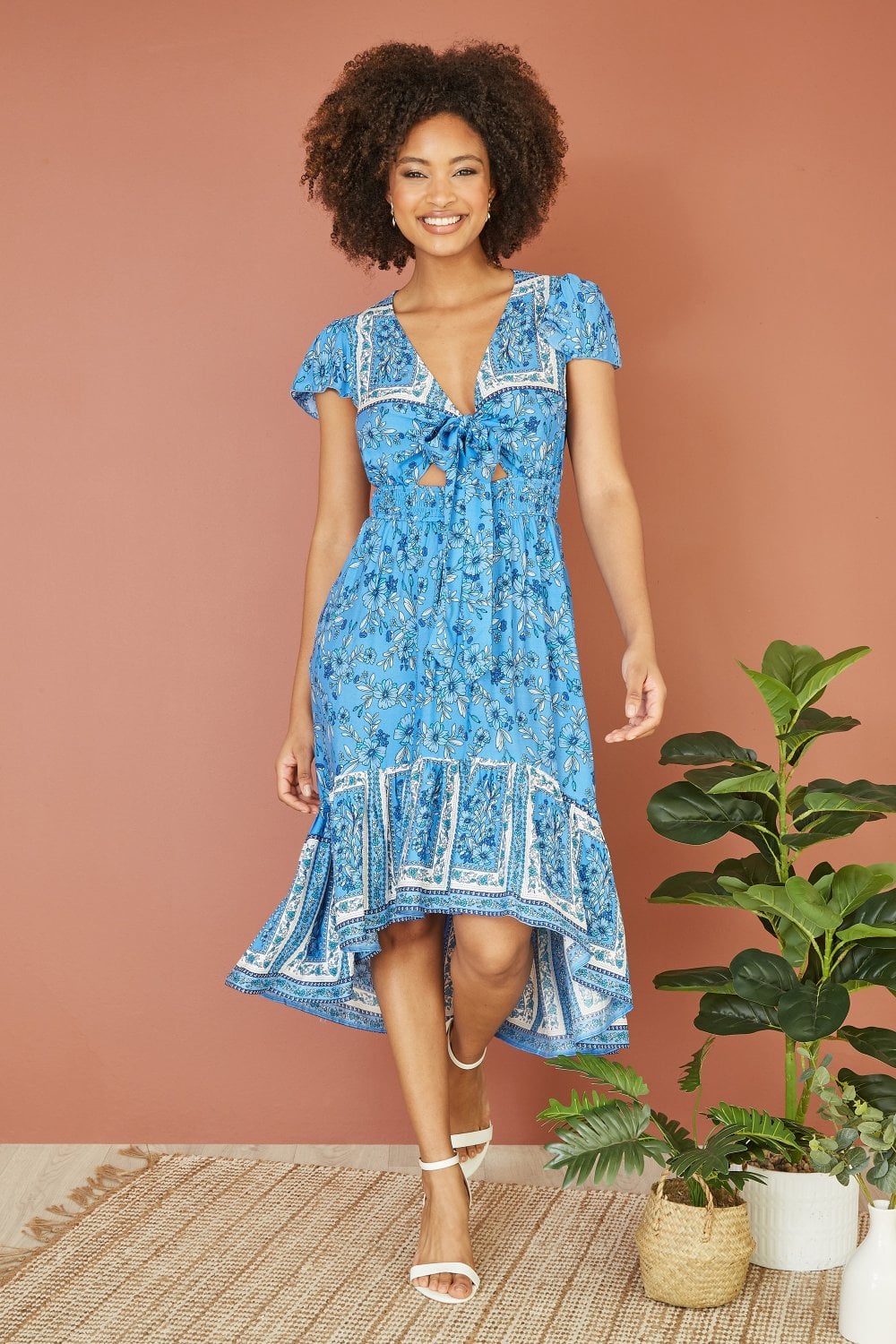 Mela Blue Ditsy Print Sun Dress With Cross Over Back Tie Front And Dip Hem Mela