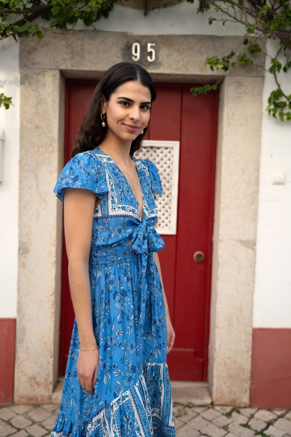 Mela Blue Ditsy Print Sun Dress With Cross Over Back Tie Front And Dip Hem Mela